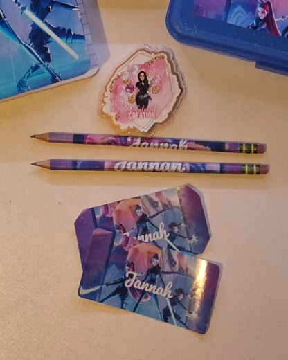 Stationery items including notebooks, pens, and glue on a table.